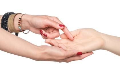 Fortune teller reading lines on woman's palm against white background. Chiromancy