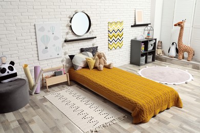 Photo of Montessori bedroom interior with floor bed and toys