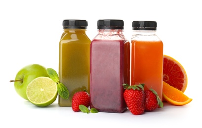 Photo of Bottles with healthy detox smoothies and ingredients on white background