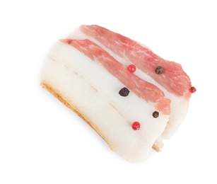 Photo of Slices of pork fatback with pepper isolated on white, top view