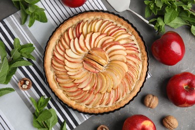 Photo of Flat lay composition with delicious homemade apple tart on grey table