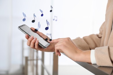 Image of Woman listening to music on mobile phone indoors, closeup. Music notes illustrations over gadget