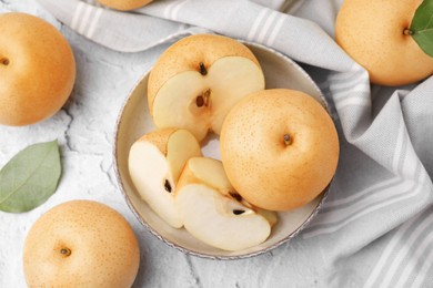 Photo of Delicious apple pears on white textured table, flat lay