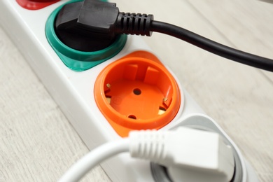 Photo of Extension cord on floor, closeup. Electrician's professional equipment