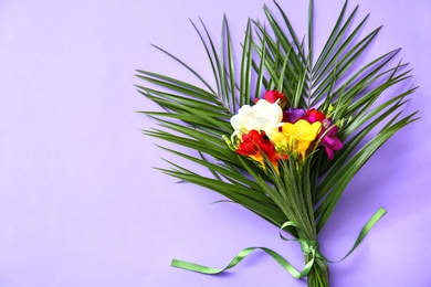 Photo of Beautiful freesia bouquet on color background