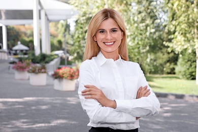 Photo of Beautiful businesswoman outdoors. Real estate agent