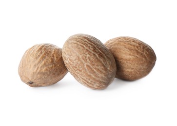 Photo of Three whole nutmeg seeds isolated on white
