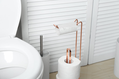 Photo of Holder with toilet paper rolls in bathroom