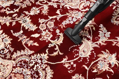 Photo of Hoovering carpet with vacuum cleaner. Space for text