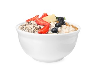 Photo of Tasty boiled oatmeal with berries, chia seeds and peanut butter in bowl isolated on white