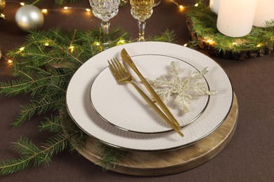 Photo of Table setting with festive lights and Christmas decor