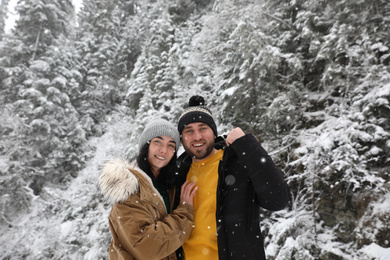 Photo of Lovely couple outdoors on snowy day. Winter vacation