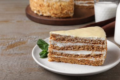 Photo of Delicious cake with condensed milk on wooden table