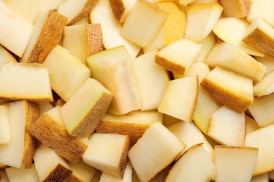 Photo of Pieces of delicious honey melon as background, top view