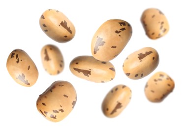 Many beans falling on white background. Vegan diet 