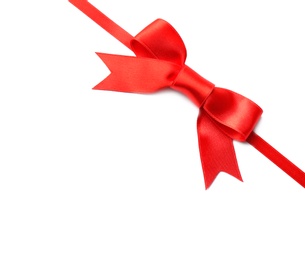 Photo of Red ribbon with bow on white background. Festive decoration