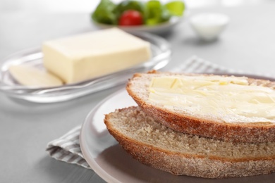 Photo of Fresh bread with tasty butter on plate