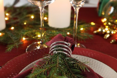 Photo of Christmas place setting with festive decor on table, closeup
