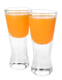Photo of Tasty tangerine liqueur in shot glasses isolated on white