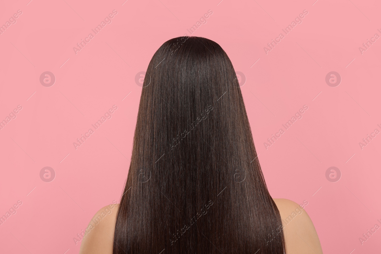 Photo of Woman with healthy hair after treatment on pink background, back view