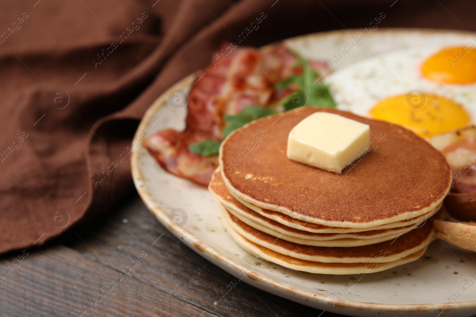 Tasty pancakes with butter on wooden table, closeup. Space for text Photo of Tasty pancakes with butter on wooden table, closeup. Space for text