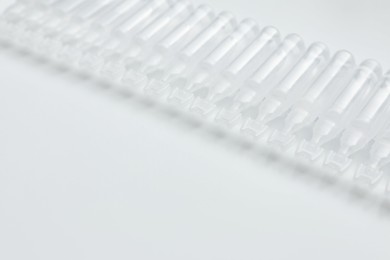 Single dose ampoules of sterile isotonic sea water solution on white background. Space for text