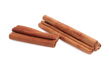 Photo of Dry aromatic cinnamon sticks isolated on white