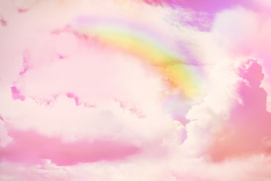 Image of Amazing sky with rainbow and fluffy clouds, toned in unicorn colors