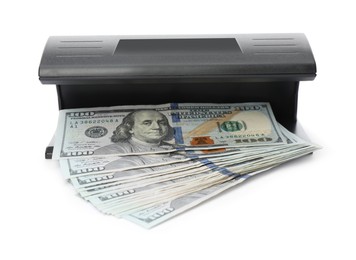 Photo of Modern currency detector with dollar banknotes isolated on white. Money examination device
