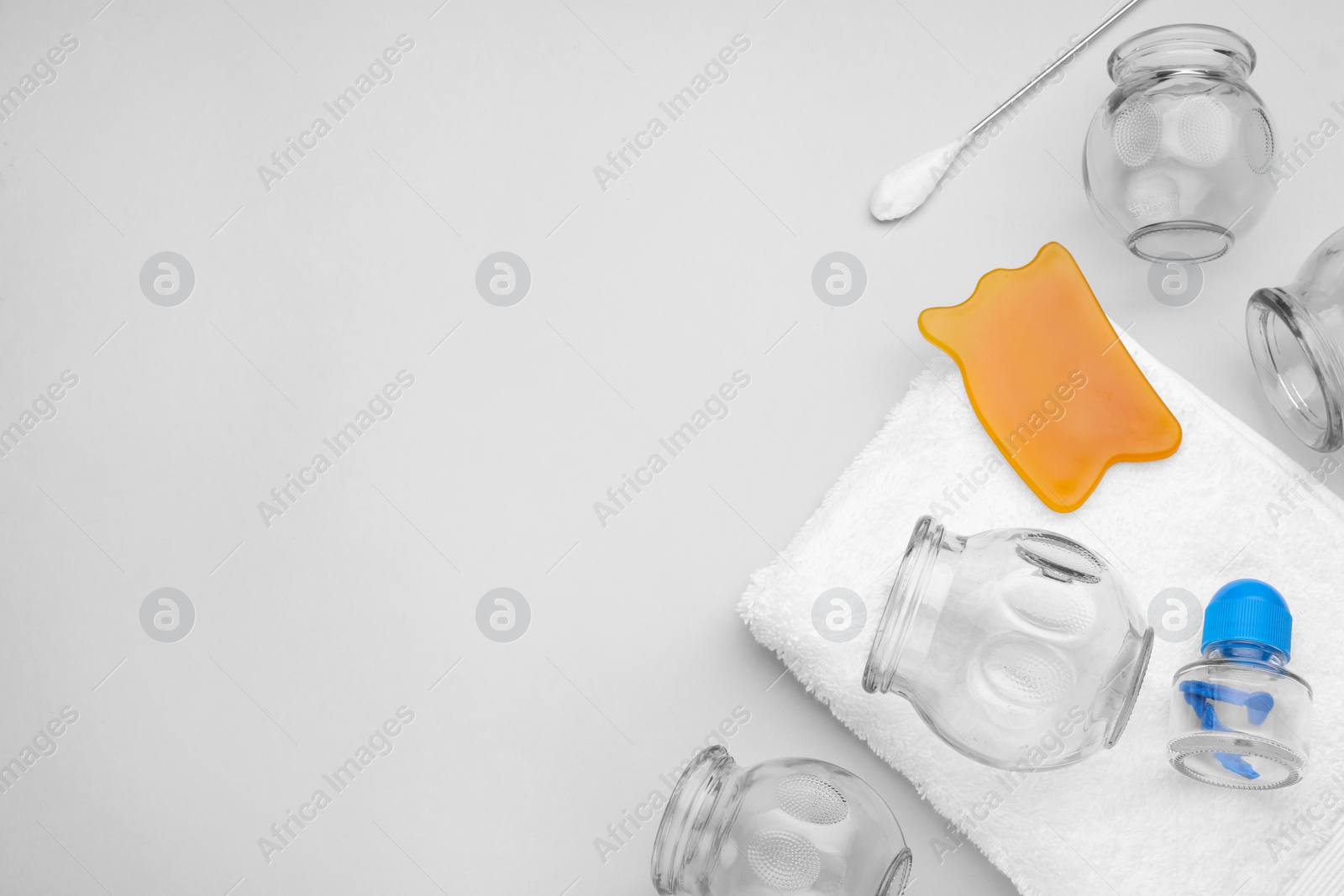 Photo of Flat lay composition with glass cups on light grey background, space for text. Cupping therapy
