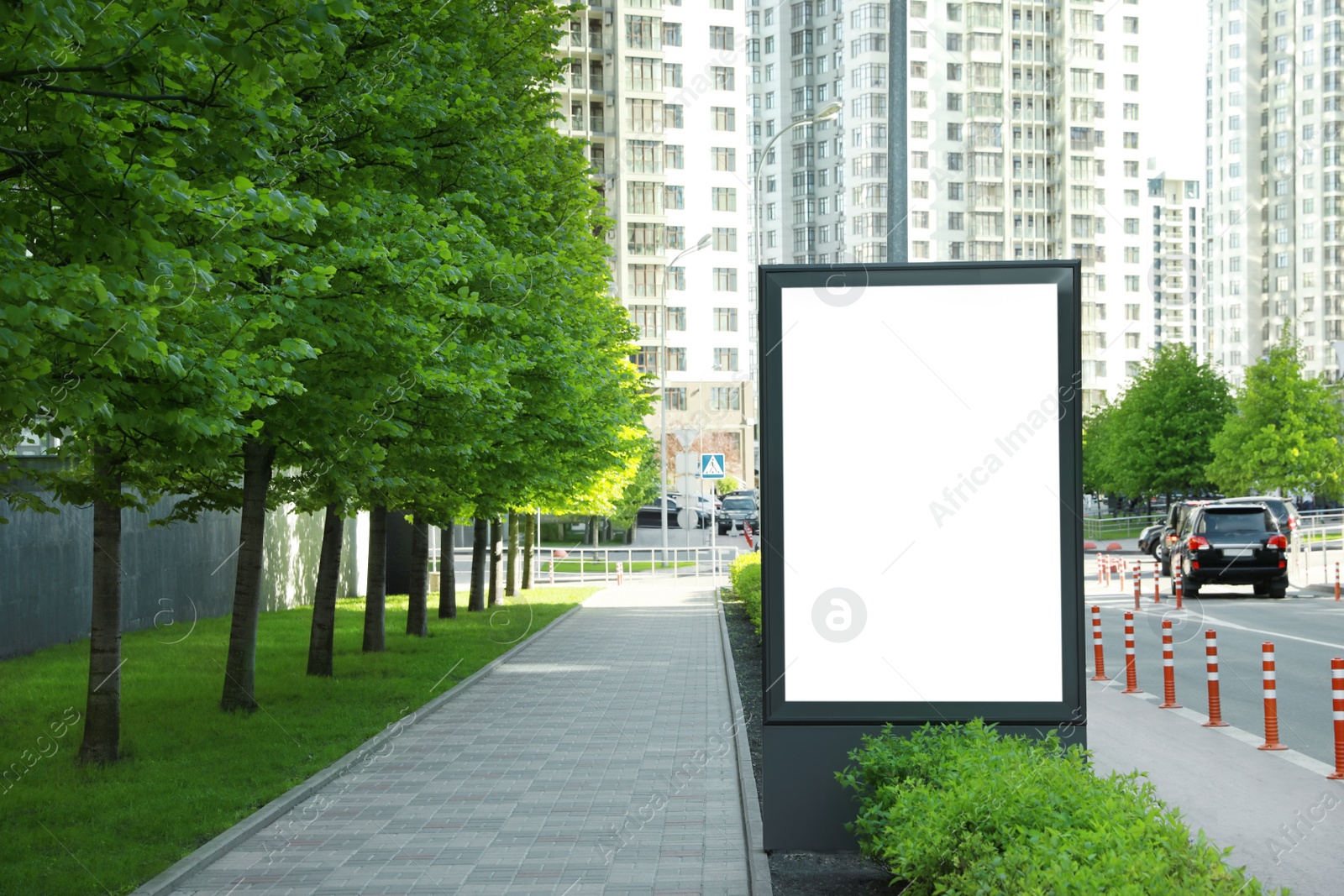 Photo of Blank advertising board on city street. Mockup for design