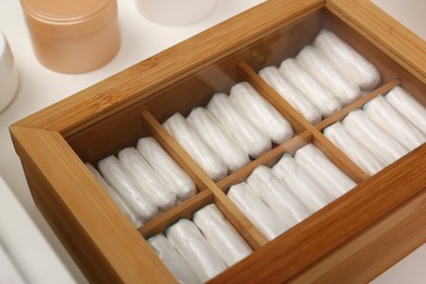 Photo of Storage of tampons in white drawer, closeup. Menstrual hygienic product
