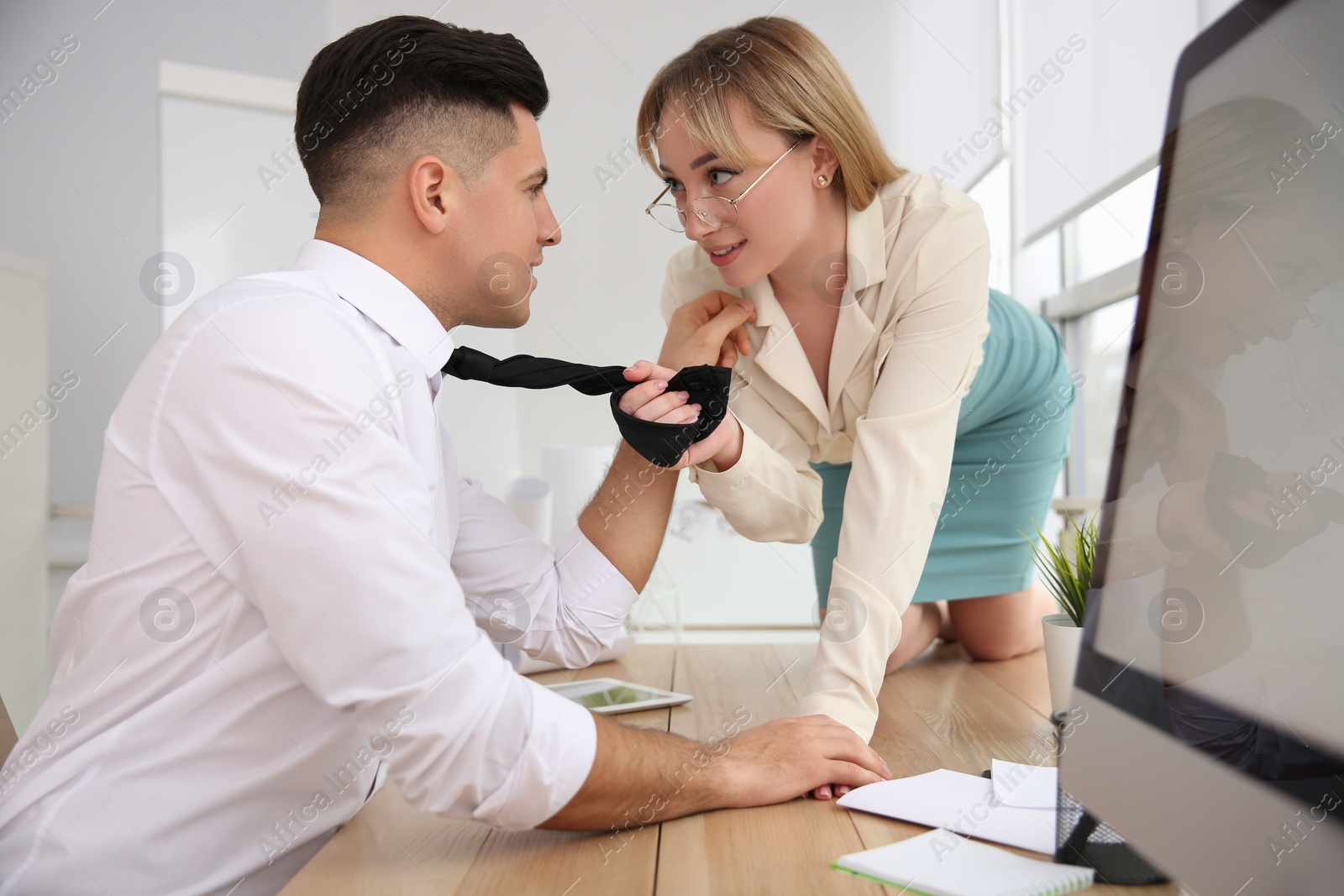 Photo of Colleagues flirting with each other during work in office