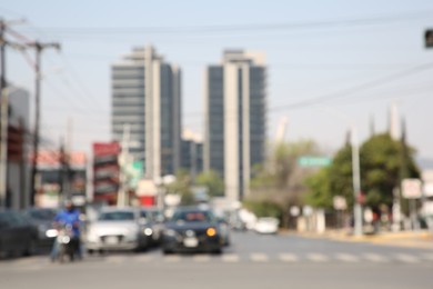 San Pedro Garza Garcia, Mexico – March 20, 2023: Blurred view of road with cars and buildings, bokeh effect