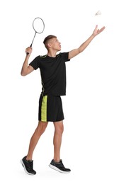 Young man playing badminton with racket on white background