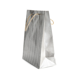 Photo of Silver paper shopping bag isolated on white. Space for design