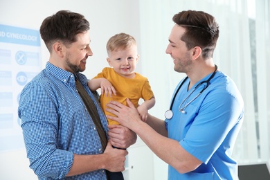 Father with child visiting doctor in hospital