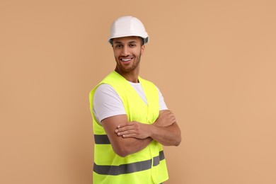 Photo of Engineer in hard hat on beige background