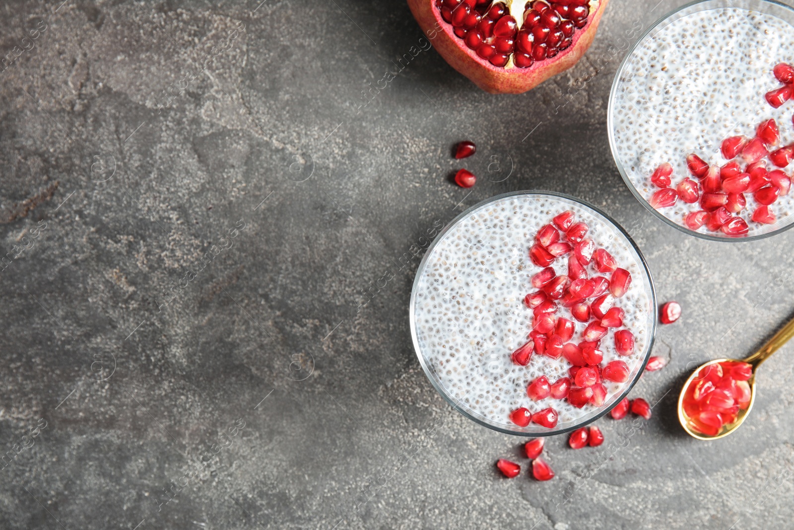Photo of Tasty chia seed pudding with pomegranate and space for text on table, flat lay