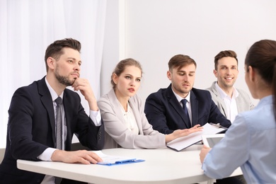 Human resources commission conducting job interview with applicant, indoors