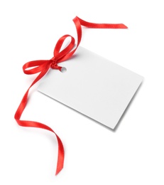 Photo of Blank gift tag with satin ribbon on white background