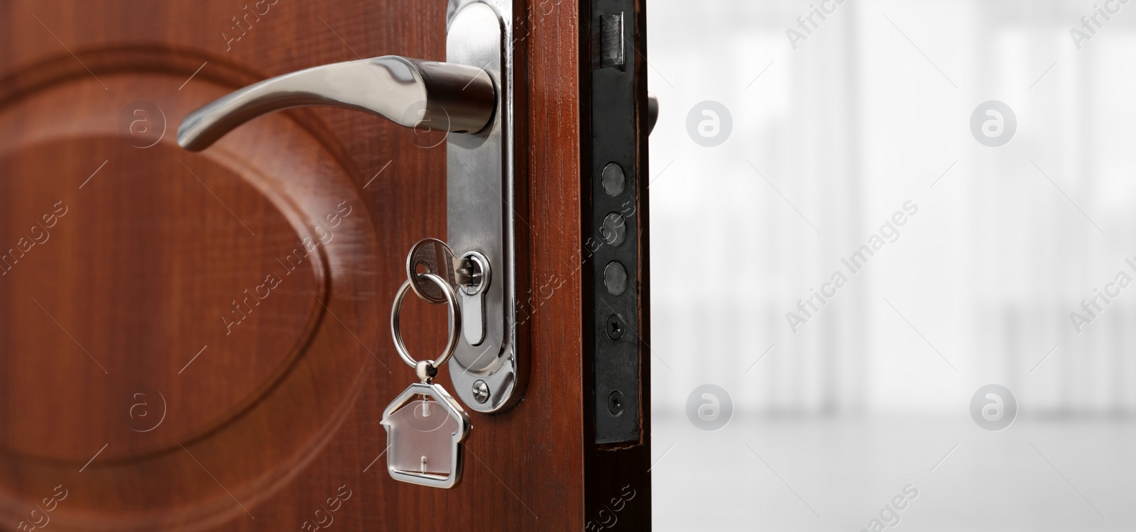 Image of Closeup view of door with key open into empty room