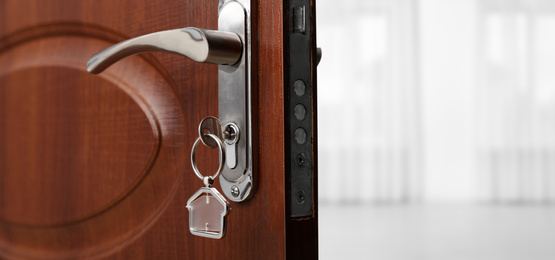 Image of Closeup view of door with key open into empty room