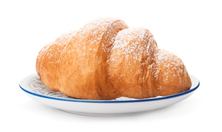 Photo of Tasty croissant with sugar powder on plate against white background