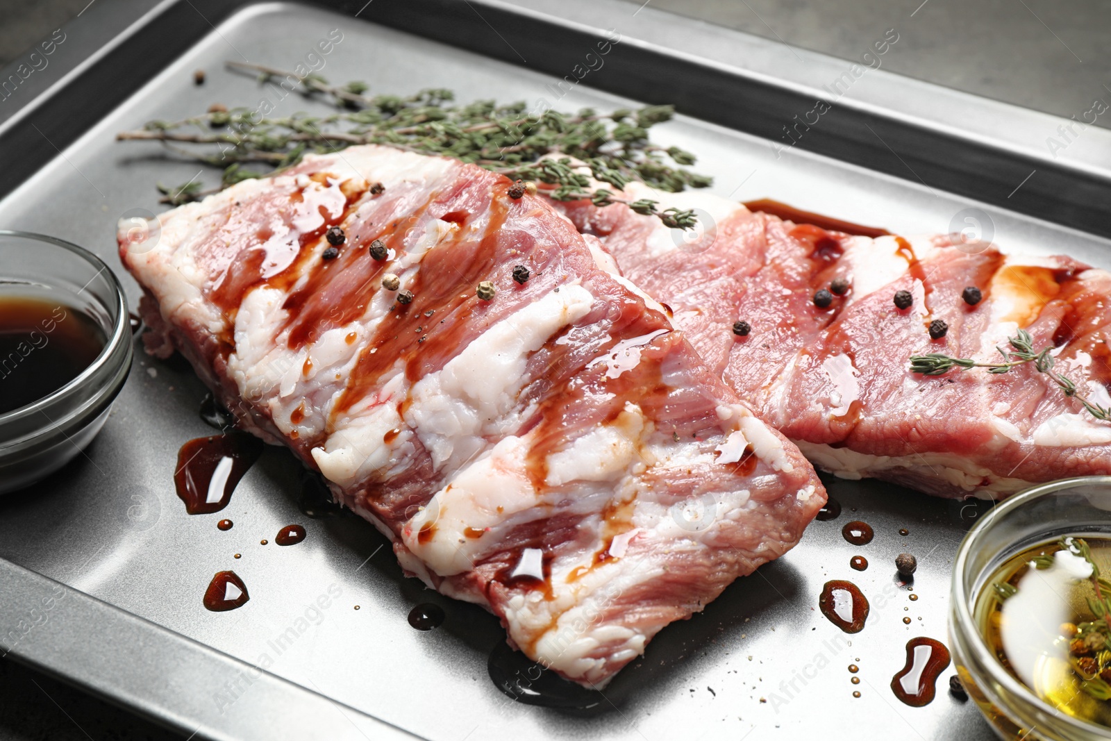 Photo of Fresh raw ribs on baking sheet, closeup