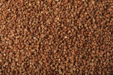 Uncooked buckwheat as background, top view. Organic wholesome product