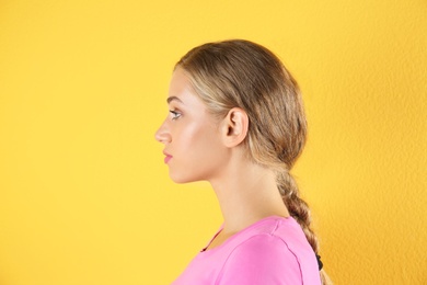 Photo of Young woman on color background. Hearing problem