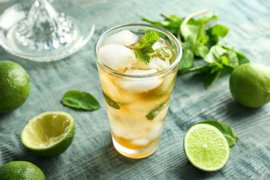 Photo of Composition with delicious mint julep cocktail on table