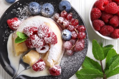 Photo of Delicious vanilla fondant served with fresh berries on white wooden table, flat lay