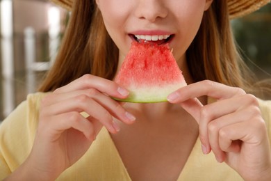 Photo of Teenage girl eating watermelon indoors, closeup view